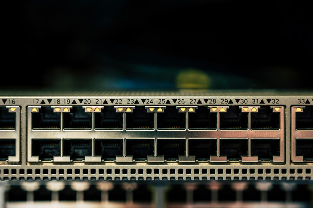 pexels-photo-2881227-2881227 Detailed view of a network switch featuring multiple ethernet ports and LED indicators.